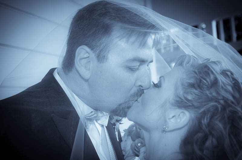 Bride and groom kissing on the porch at Camarillo Ranch House Bride and groom kissing on the porch at Camarillo Ranch House